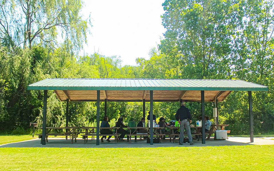 Group of people in picnic shelter with tables